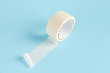Adhesive tape roll on blue background