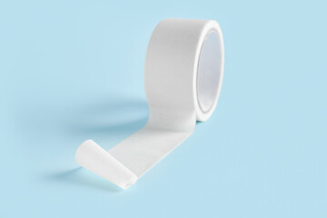 Adhesive tape roll on blue background