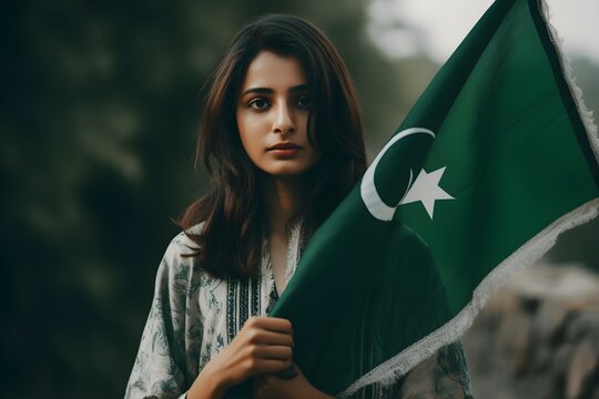 Portrait of a woman holding a Pakistan flag in his hand outdoors