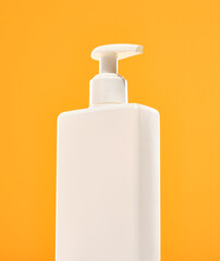 The dispenser is white with liquid soap on a bright background. Hygiene and cleanliness.