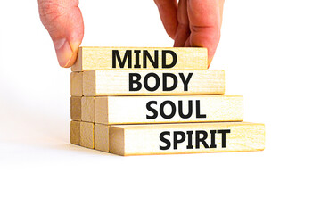 Mind body soul spirit symbol. Concept words Mind Body Soul Spirit on wooden blocks. Beautiful white...