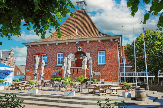 Arcen, Netherlands - June 16. 2023:   Beautiful red brick house old town hall with restaurant cafe terrace