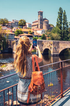 Woman taking photography with mobile phone in Clisson- Brittany in France