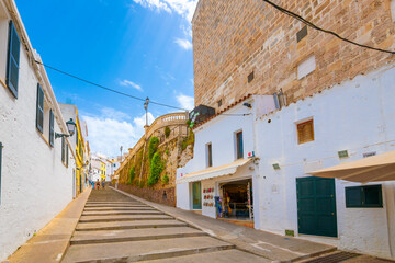 Fototapeta na wymiar A long flight of wide steps leading to the historic medieval old town of Ciutadella de Menorca, a whitewashed fishing village on the Mediterranean on the Balearic island of Menorca, Spain.