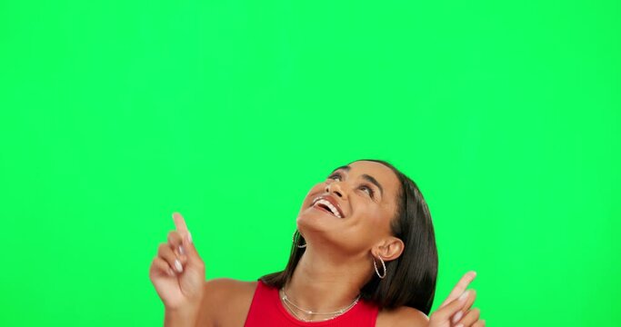 Happy woman, dancing and pointing on green screen for advertising against a studio background. Portrait of excited female person in dance for advertisement, sale discount or notification on mockup