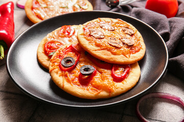 Plate with different tasty mini pizzas, closeup