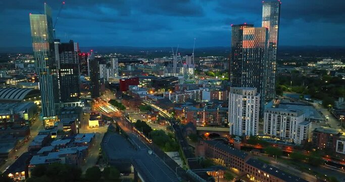 Manchester Castlefield at evening hours as trams and trains move down below. Aerial View. 