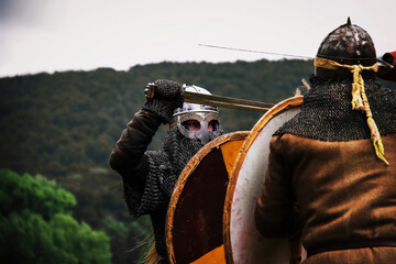 Two fighting viking warriors from early middle ages.