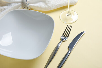 Beautiful table setting on beige background, closeup
