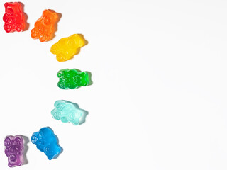 Colorful Gummy bears in rainbow colors arranged into a half circle, isolated on white background