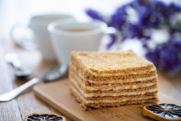 A piece of layered honey cake, tasty dessert, selective focus