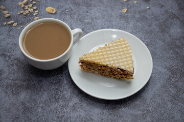 a cup of coffee with milk and waffles with condensed milk