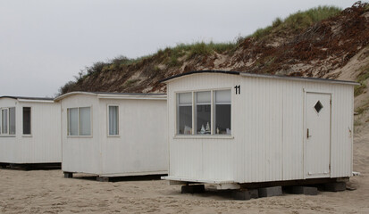 Fototapeta na wymiar The beautiful beach cabins at Blokhus Beach in Denmark