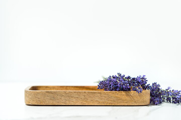 Cosmetics and skin care product presentation scene made with lavender flowers and wooden tray....