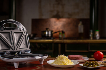 Pizza waffles, piffle. Waffles stuffed with sausage, cheese, tomatoes on a plate. Place for text.