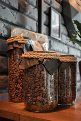 Close-up of coffee beans in a glass jar on a wooden background