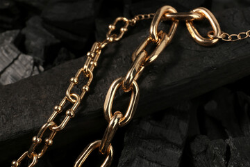 Beautiful chain bracelets on black charcoal, closeup