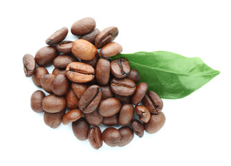 Heap of coffee beans and leaf on white background