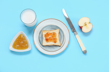 Plate of delicious toast with jam, milk and apple on color background