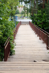 photo wooden bridge with railings over the river