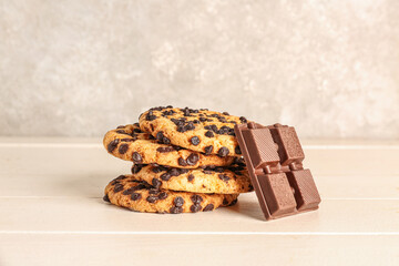 Cookies and chocolate on white wooden table near wall