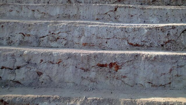 Ledges of a quarry after blasting and drilling operations. Aerial view of open-pit mine 