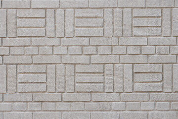 wall of painted white bricks in a decorative artisanal pattern alternating rows of basket weave and English bond, background, copy space