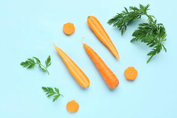 Naklejka na ściany i meble Fresh carrot and slices on turquoise background