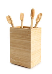 Bamboo tooth brushes in holder on white background