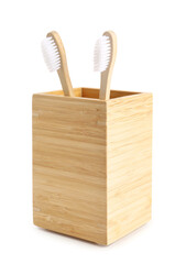 Bamboo tooth brushes in holder on white background