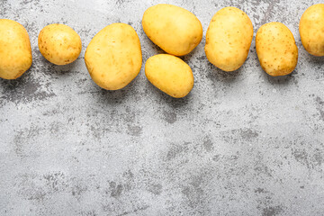 Raw baby potatoes on grey background