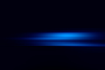 Neon blue motion light trails over black background. Abstract speed effect. Rays of light moving fast over dark background
