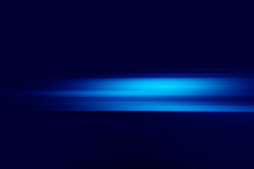 Neon blue motion light trails over black background. Abstract speed effect. Rays of light moving fast over dark background