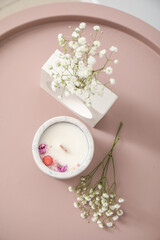Gypsophila flowers and candle on table, closeup