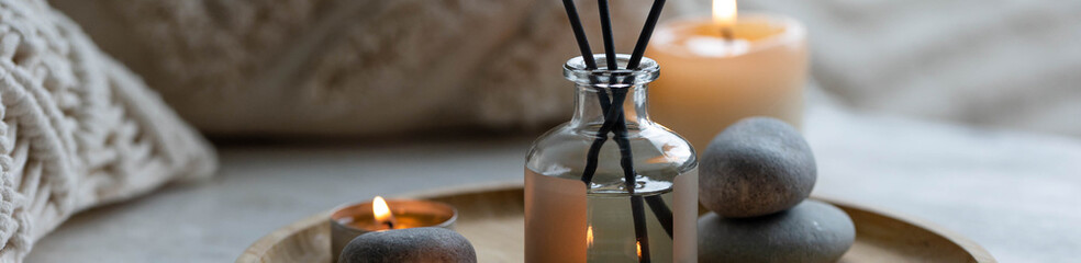 Aromatherapy, atmosphere of relax, serenity and pleasure. Concept of spa treatment in salon. Natural organic essential oil, towel, burning candles. Anti-stress, detox procedure, wellness. Banner