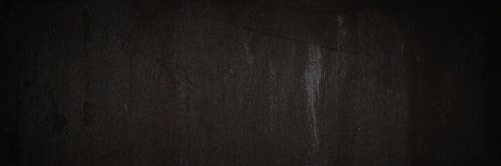 Old rusted metal texture. The surface of an uneven iron wall. Dark wide panoramic background for design.