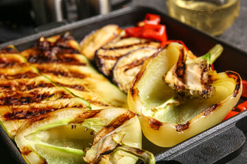 Baking dish with tasty grilled vegetables on table