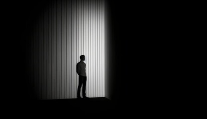 Dark empty room with the silhouette of a man standing alone. Based on Generative Ai.