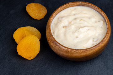 fresh yogurt made from milk with pieces of dried apricots