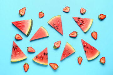 Pieces of fresh watermelon and strawberries on blue background