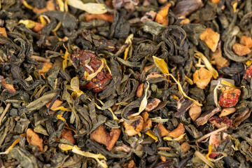 fresh green tea with pieces of fruit and berries