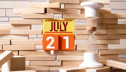 July 21st. Day 21 of month, wooden color calendar on office background. Summer time. Empty space for text