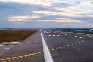 In the airport setting, a lengthy and unobstructed runway reaches out into the distance, adorned...