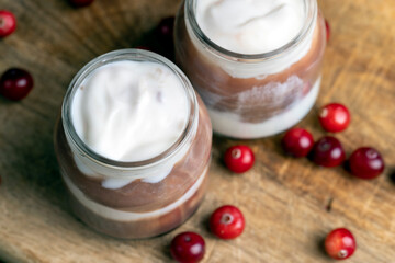 Yogurt with plum jam in a jar
