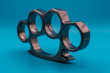 Silver Brass Knuckles Standing Angled Left Isolated on Blue Background