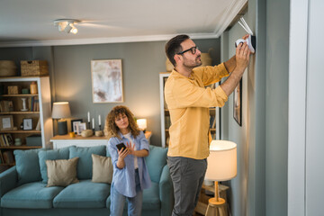 Couple at home connect and install cctv security surveillance camera