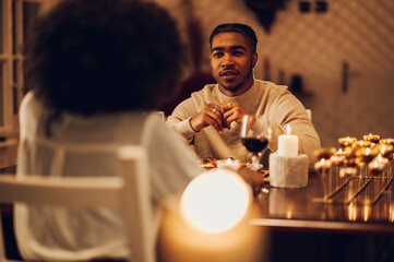 Smiling african american man having a romantic date with his girlfriend at home