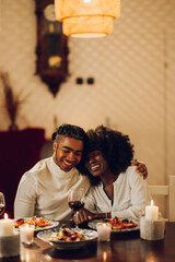 African american couple having romantic date and drinking wine at home