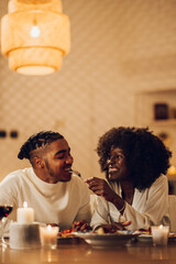 Fototapeta na wymiar African american couple having romantic dinner date at home