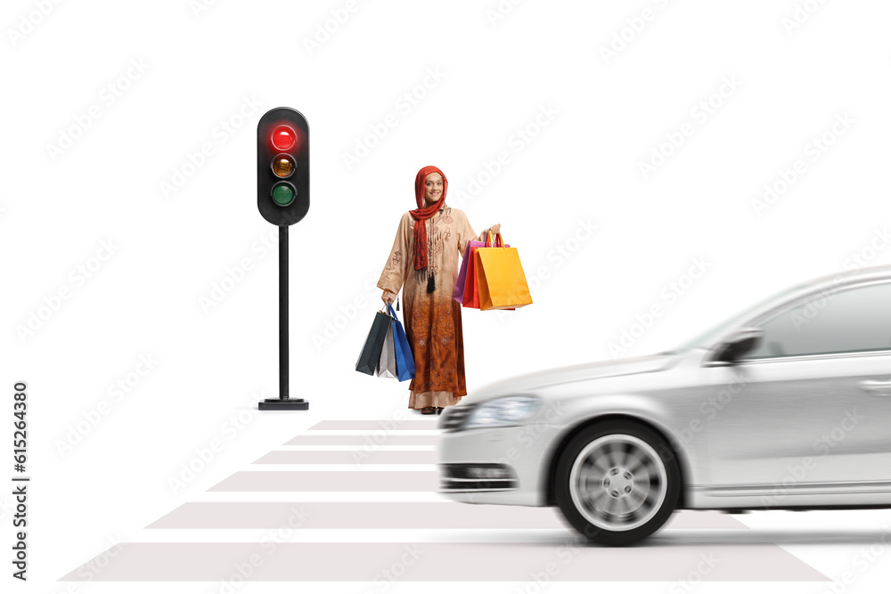 Canvas Prints full length portrait of a muslim woman with shopping bags waiting at traffic lights